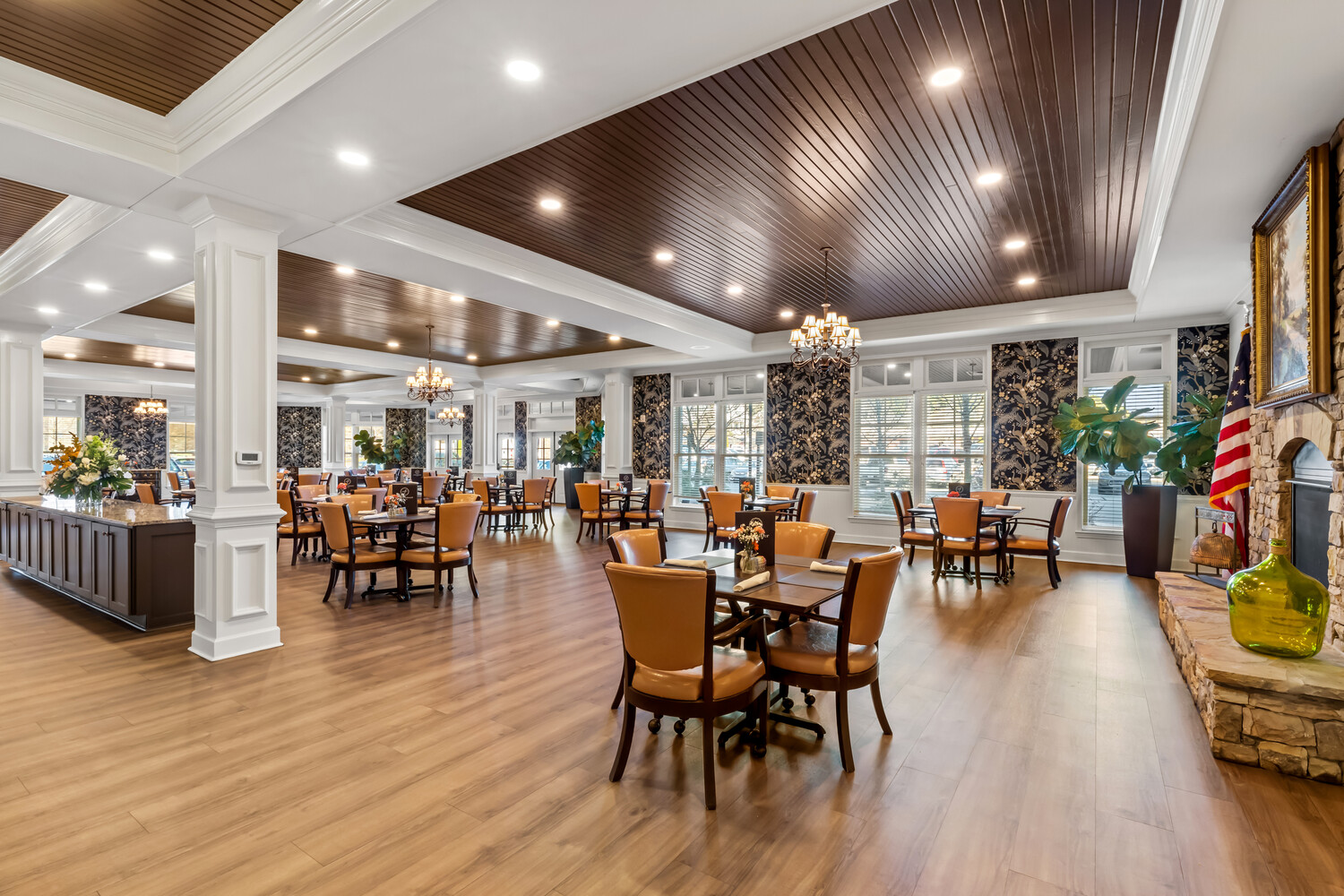 A grand open living and dining hall at this senior living community in Acworth, GA, featuring soaring ceilings, warm wood floors, and abundant natural light that fills the space with life and energy.