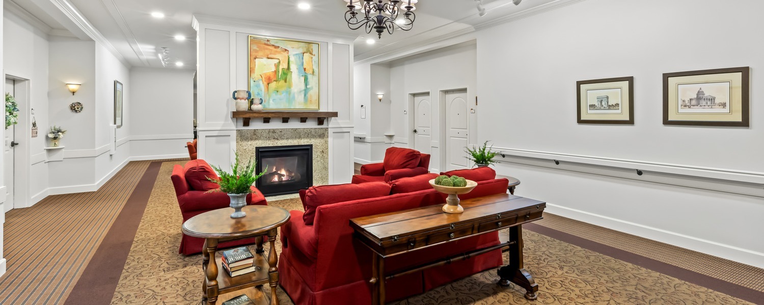 Cozy common area featuring a fireplace, artwork, and comfortable seating, part of the resort-style senior amenities at our senior living community in Acworth, GA