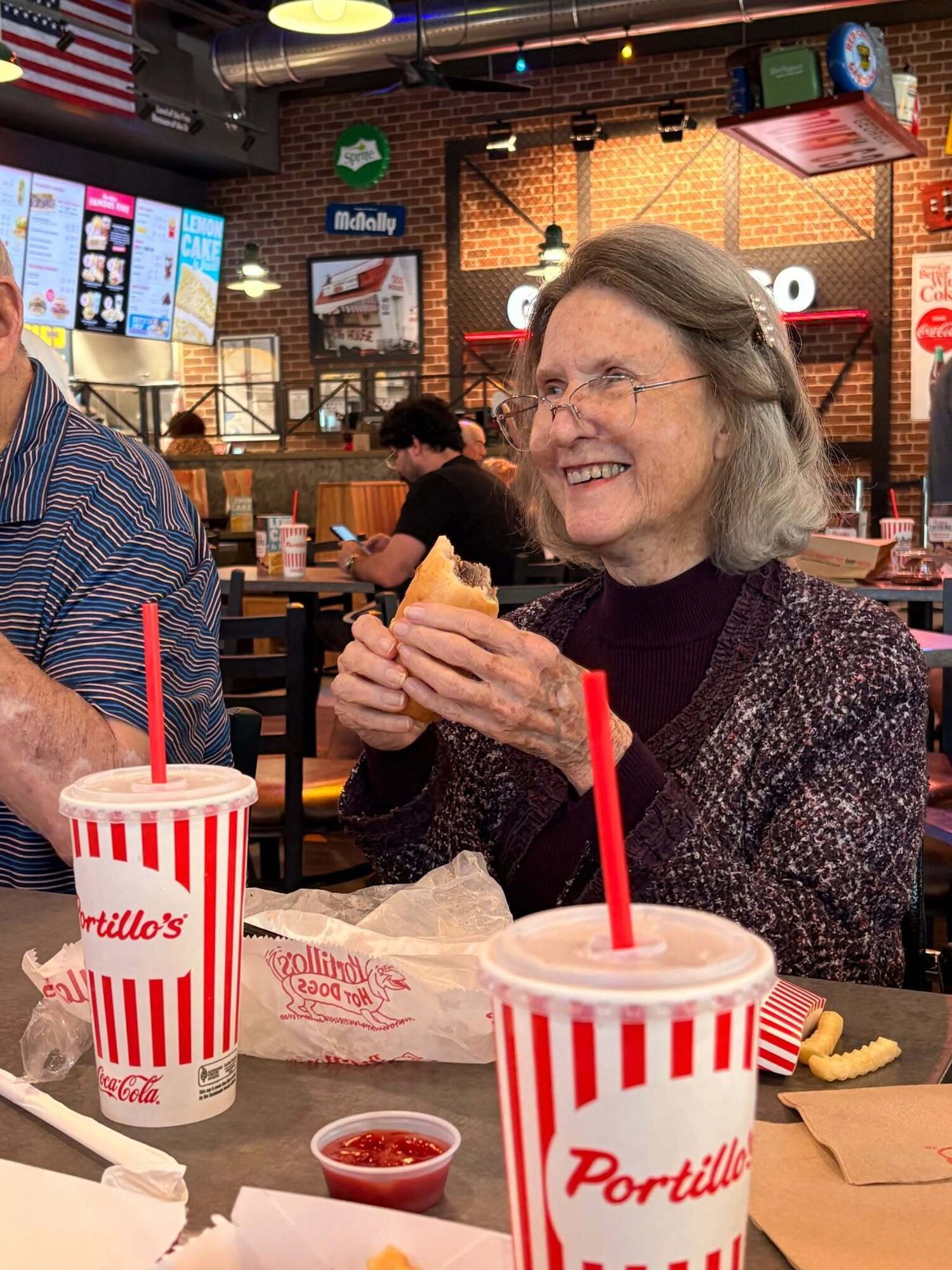 Resident enjoying a meal during a community outing to a local restaurant, part of the active senior lifestyle at our senior living community in Acworth, GA