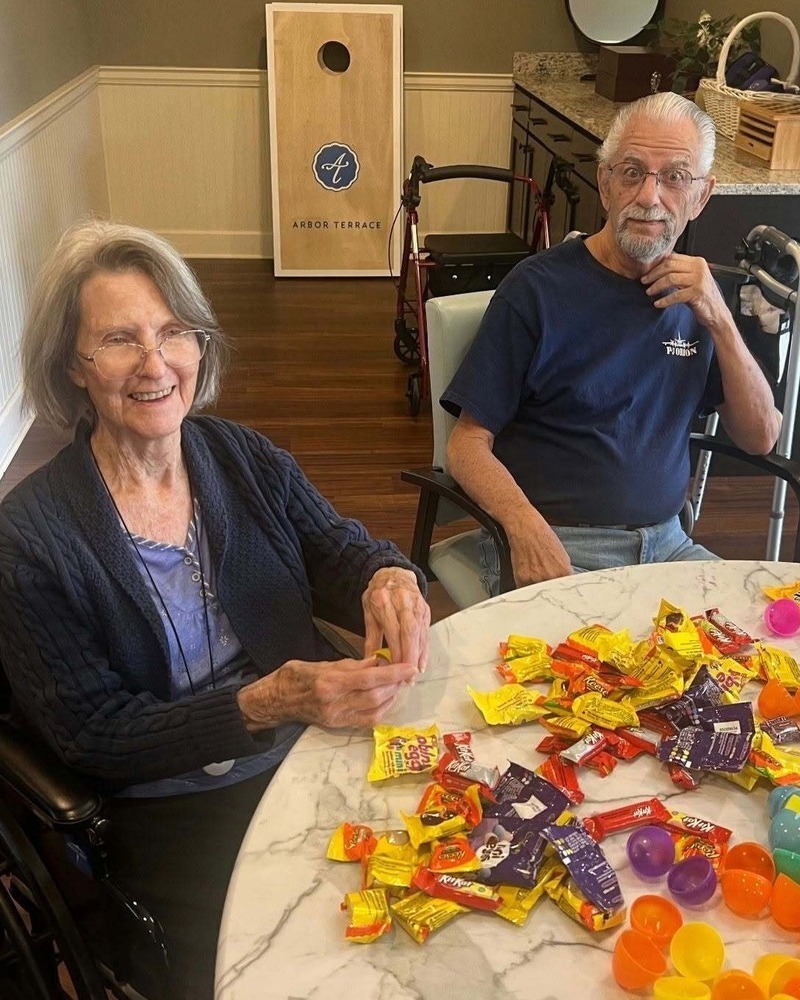 Residents smiling together while enjoying a hands-on craft activity at our senior living community in Acworth, GA, reflecting our active senior lifestyle