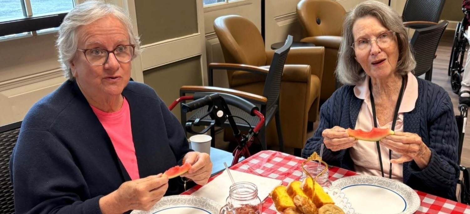 Residents sharing a meal together at our senior living community in Acworth, GA, part of our engaging senior lifestyle programs