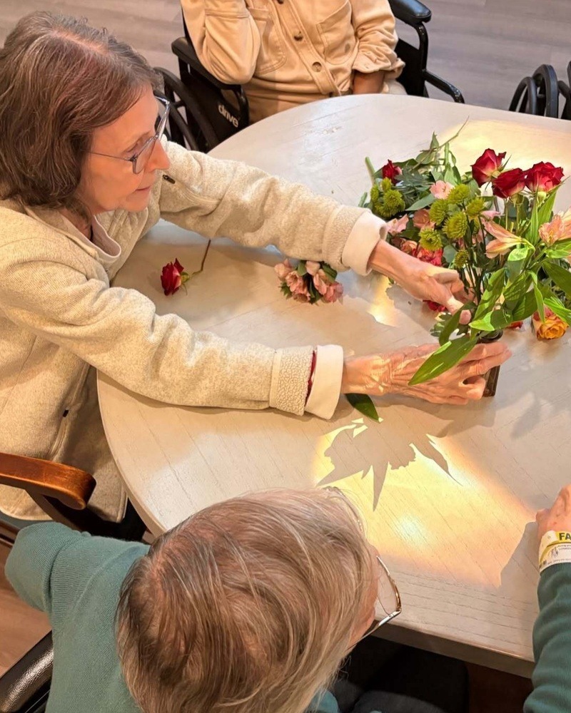 Residents arranging fresh flowers together at our senior living community in Acworth, GA, part of our engaging senior lifestyle programs