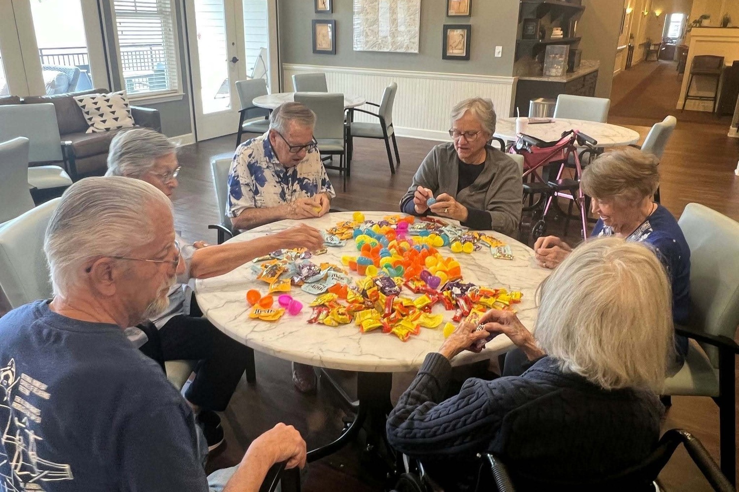 Residents gathered around a table for a hands-on craft activity at our senior living community in Acworth, GA, part of our engaging senior lifestyle programs