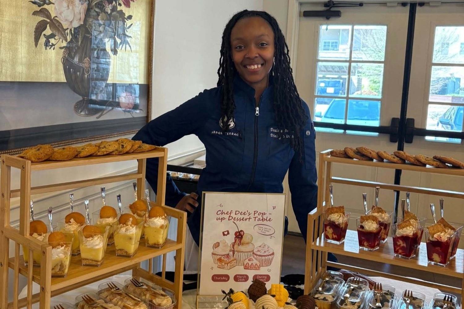 Staff member showcasing a fresh bakery display at our senior living community in Acworth, GA, part of our resort-style senior dining amenities