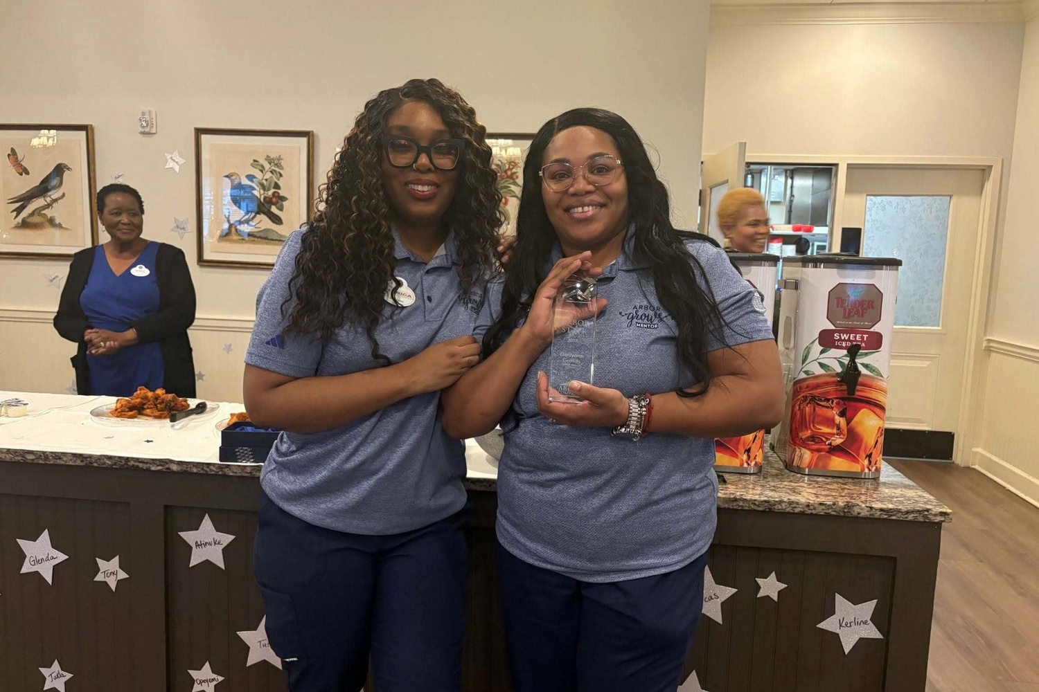 Staff members celebrating together at our senior living community in Acworth, GA, reflecting the warm hospitality of our resort-style senior amenities