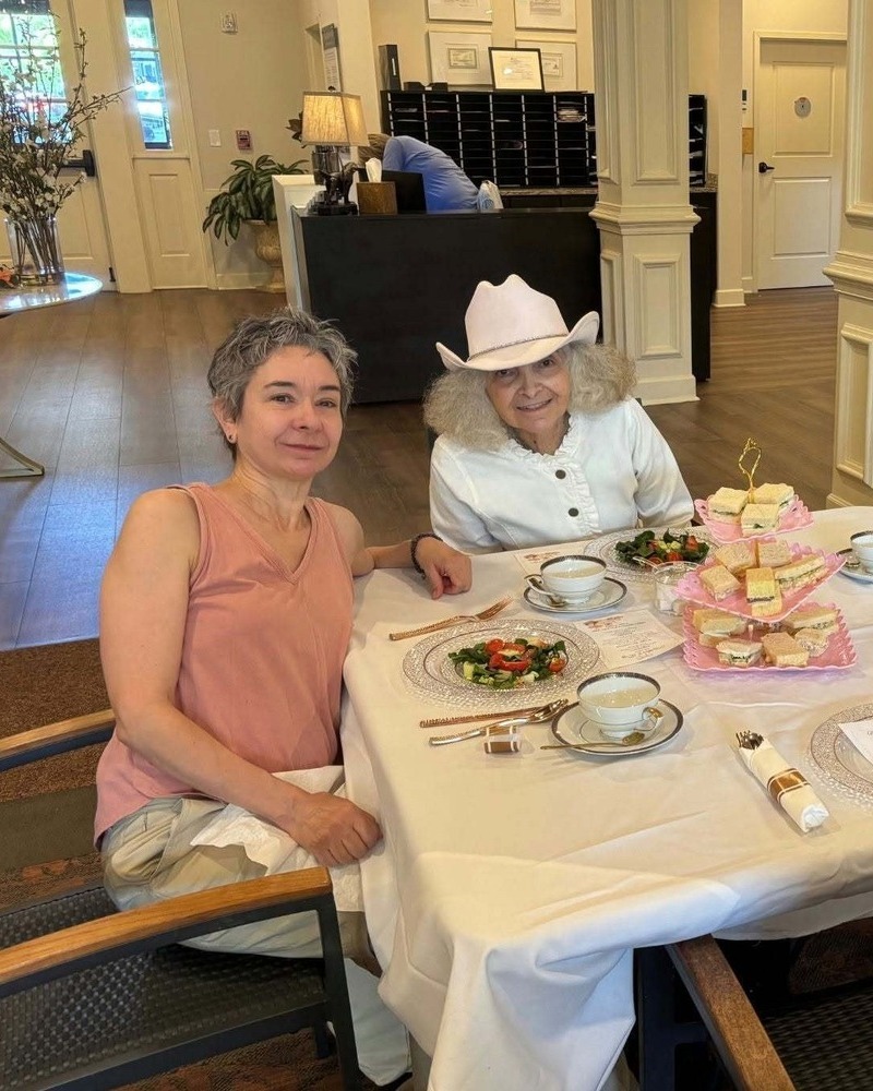 Residents enjoying a formal tea service together at our senior living community in Acworth, GA, part of our resort-style senior amenities