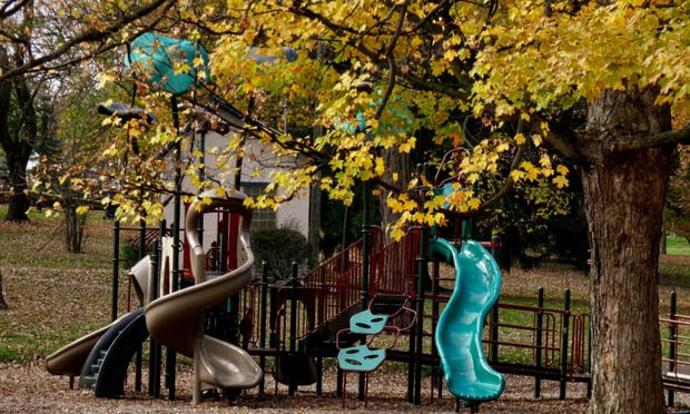 A colorful playground sits beneath golden autumn foliage in a local park, reflecting the vibrant community life near senior living in Sandy Springs, GA and Roswell, GA.
