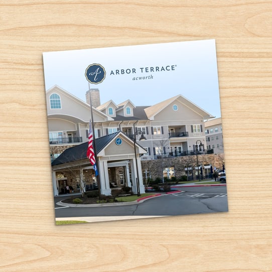 Arbor Terrace Acworth brochure cover showing the exterior of the senior living community building with a circular driveway and American flag out front.