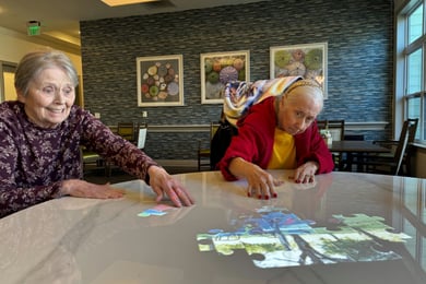 Residents using the Tovertafel participating in an interactive puzzle play game