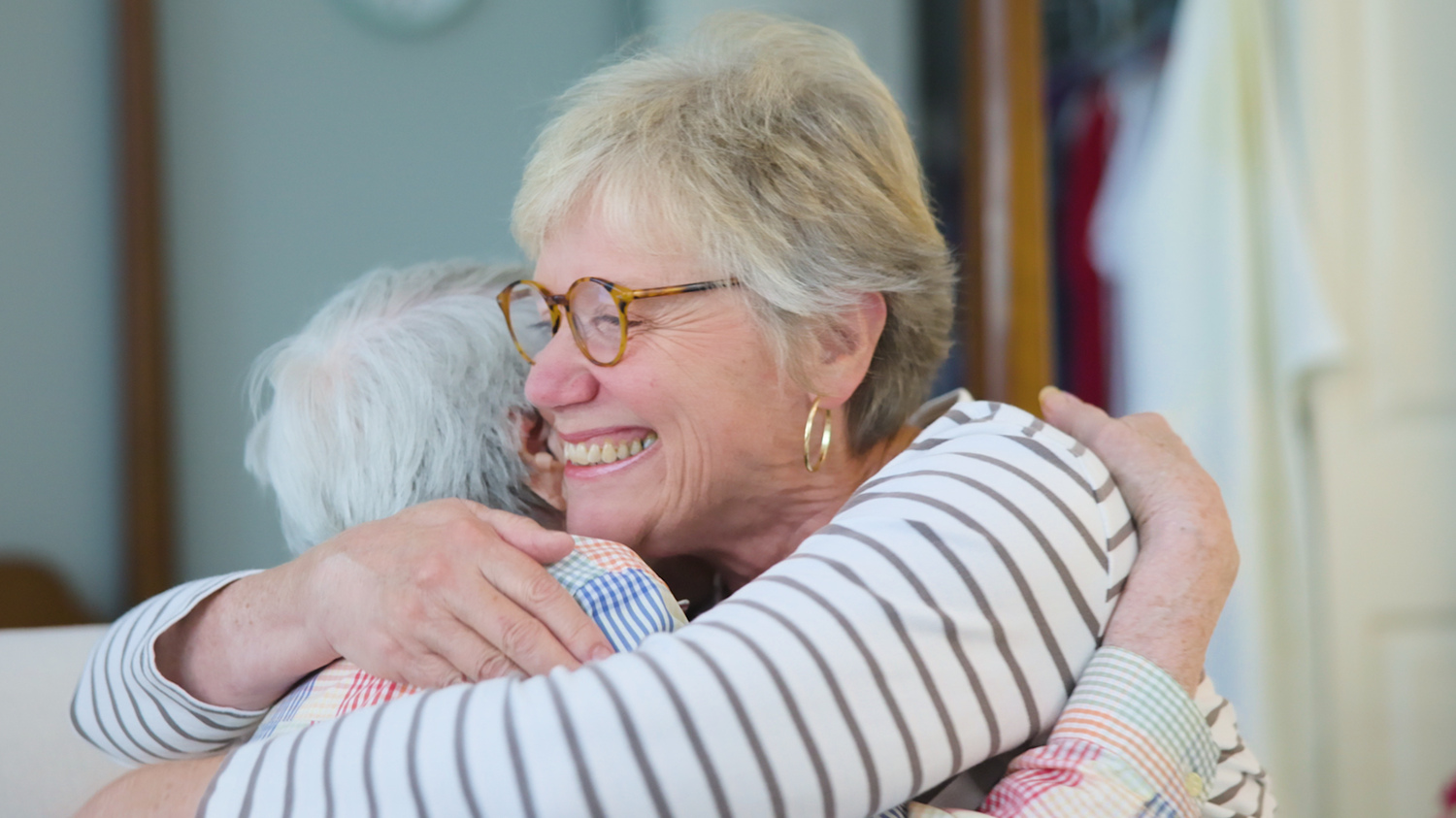 Two people share a heartfelt embrace, reflecting the genuine warmth and connection found at Arbor Terrace Asheville's senior living community in NC.