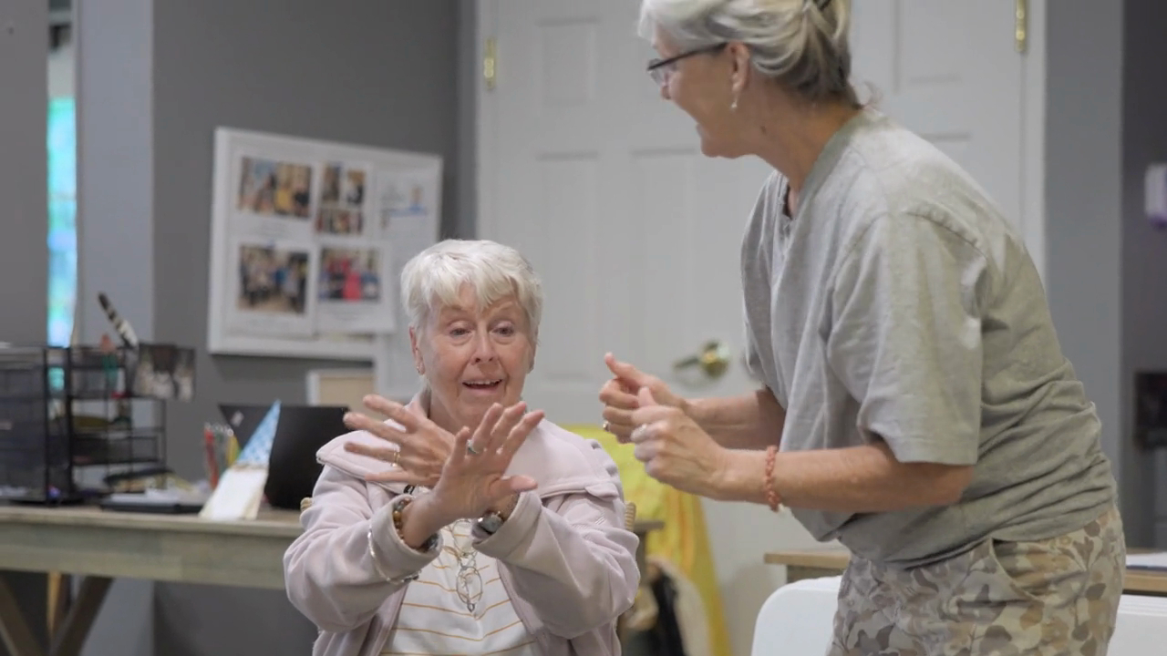 asheville - senior female resident dancing with female staff member