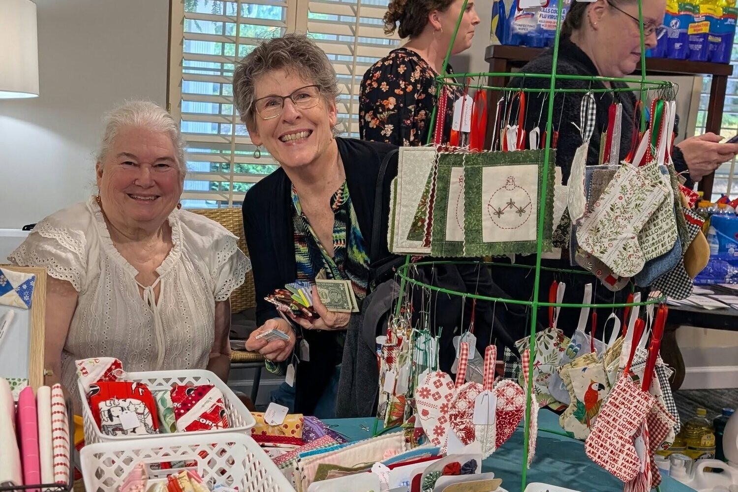 Residents browse a festive holiday gift market at Arbor Terrace Athens, enjoying a seasonal community event together.