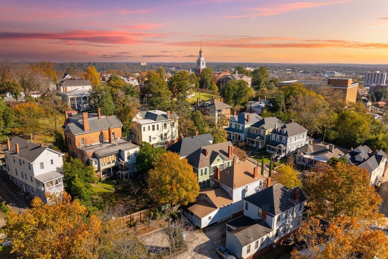A sunset aerial view of a historic neighborhood with tree-lined streets near Bogart, GA, close to Arbor Terrace Athens, offering senior living in Bogart, GA and senior living in Athens, GA.