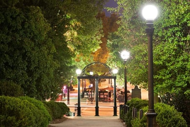 The University of Georgia's iconic arch lit up at night, just minutes from Arbor Terrace Athens, a senior living community near the University of Georgia in Athens, GA.