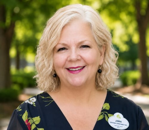 A smiling staff member at Arbor Terrace Athens, a senior living community in Athens, GA, photographed outdoors with a lush green background.