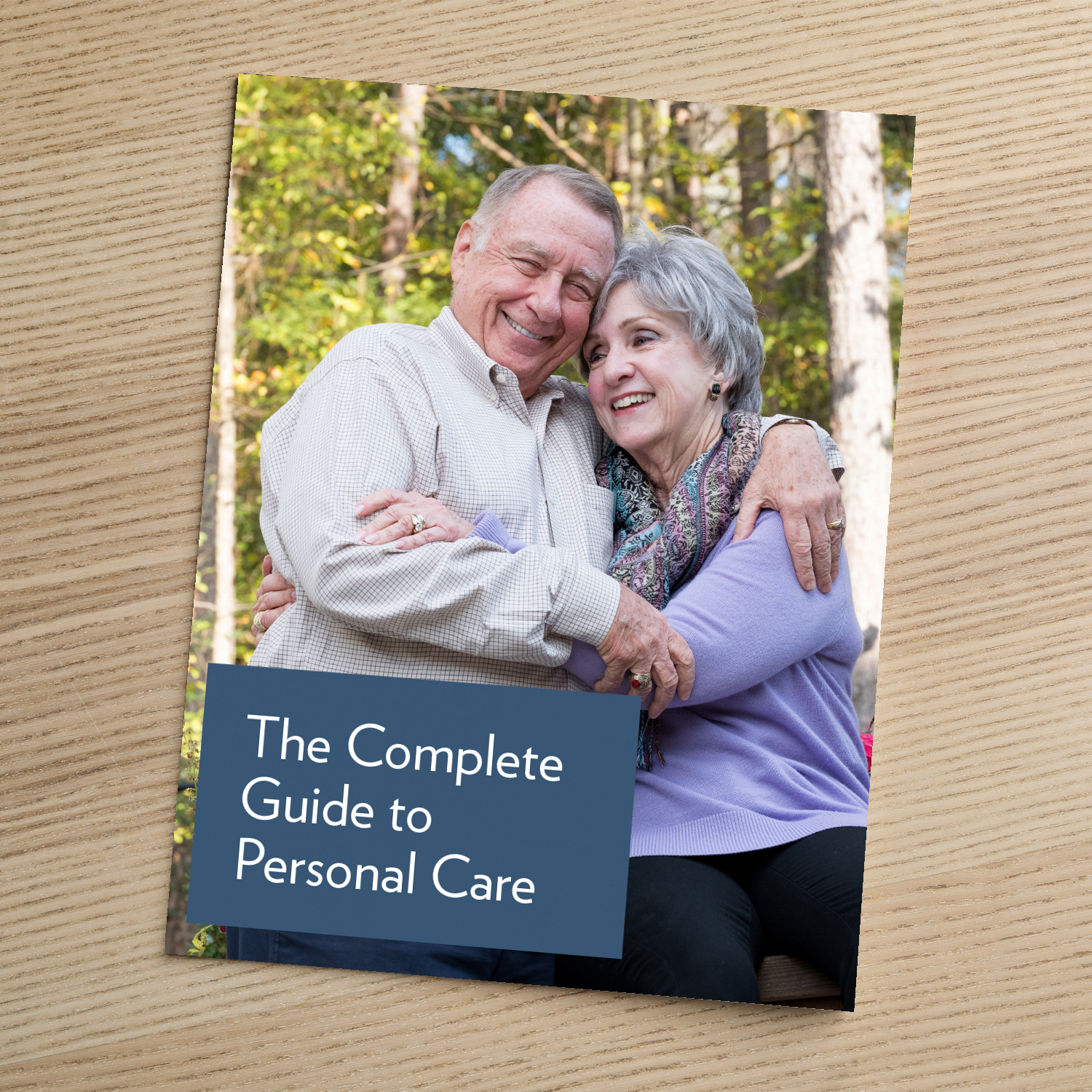 Cover of 'The Complete Guide to Personal Care,' showing a smiling older couple embracing outdoors surrounded by trees.