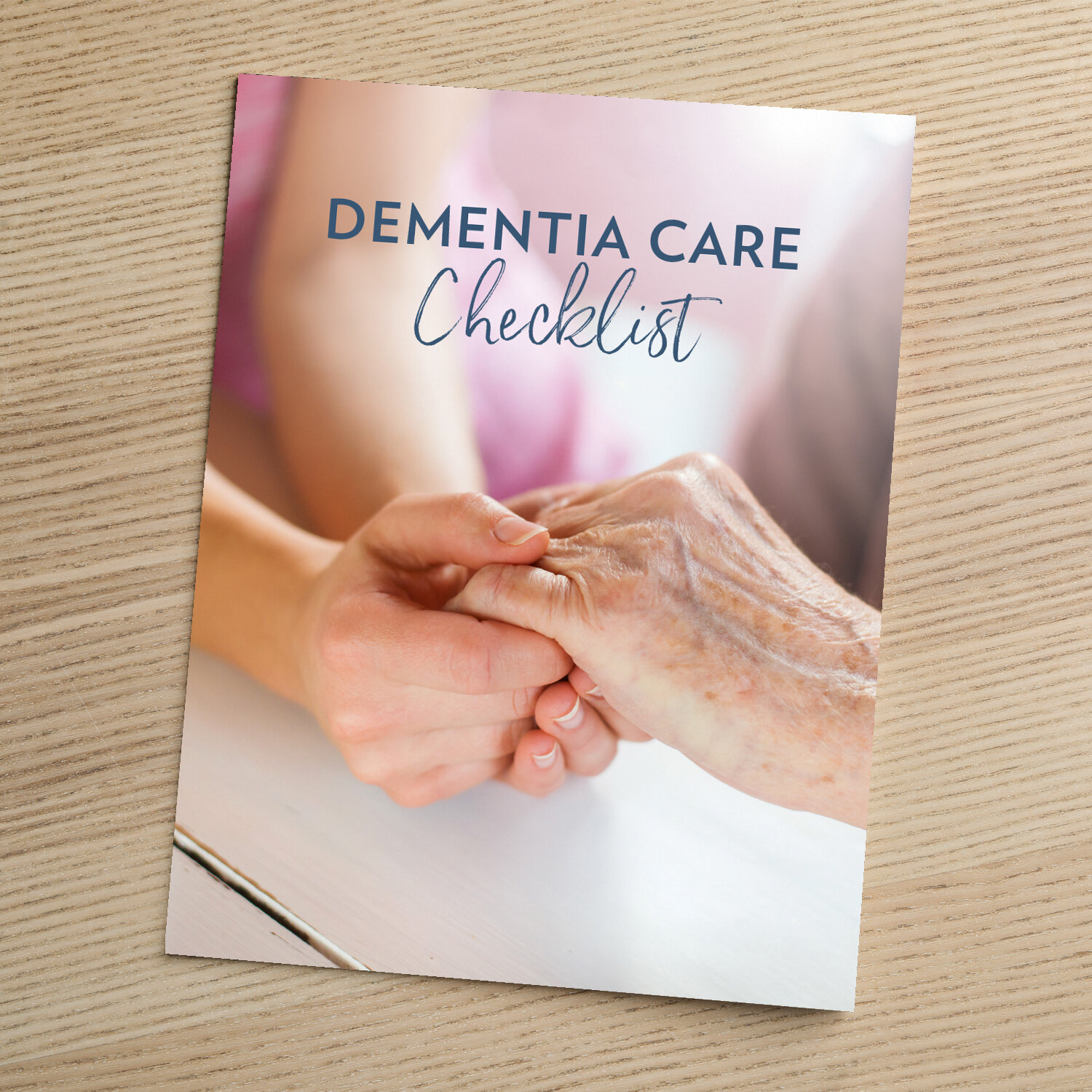 Cover of the 'Dementia Care Checklist,' showing a younger person's hands gently holding an older adult's hand in a caring gesture.