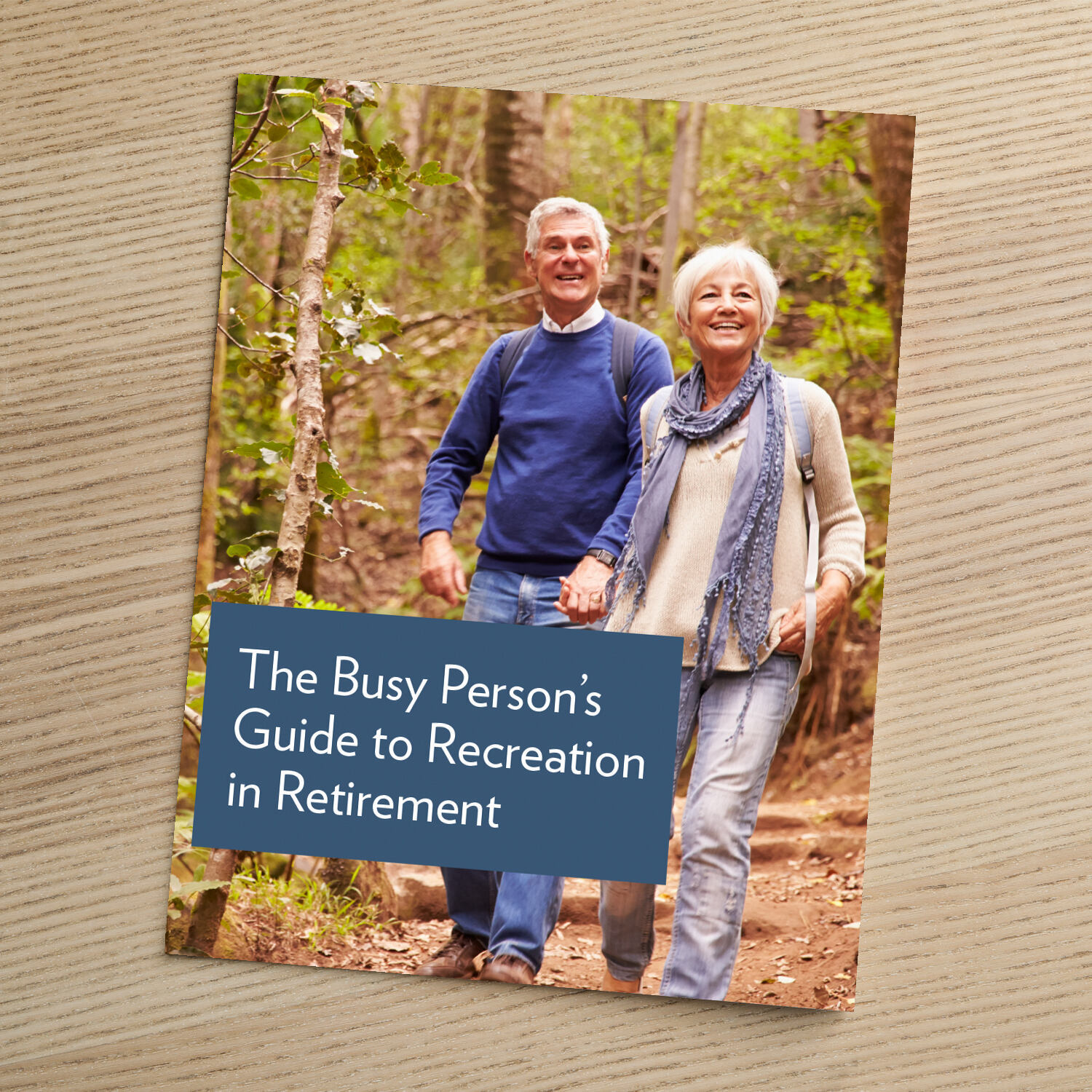 Cover of a guide titled "The Busy Person's Guide to Recreation in Retirement," featuring a happy older couple walking hand-in-hand on a wooded trail.