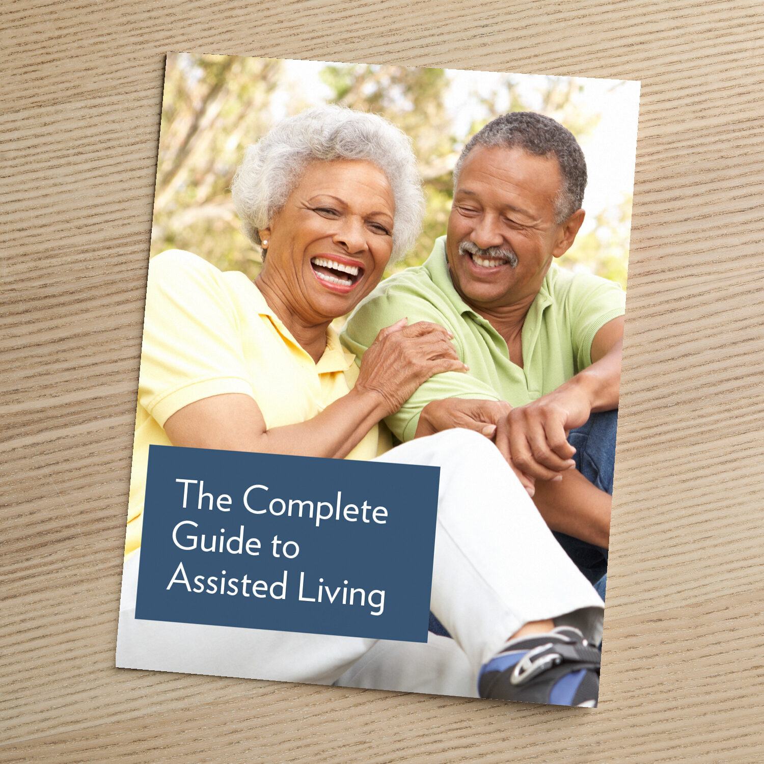 Cover of "The Complete Guide to Assisted Living," featuring an older couple laughing and enjoying each other's company outdoors.