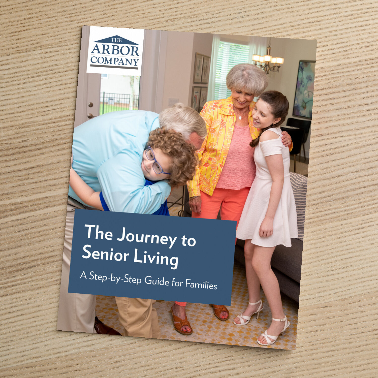 Cover of The Arbor Company guide titled "The Journey to Senior Living: A Step-by-Step Guide for Seniors," featuring an older couple toasting with wine glasses over a meal.