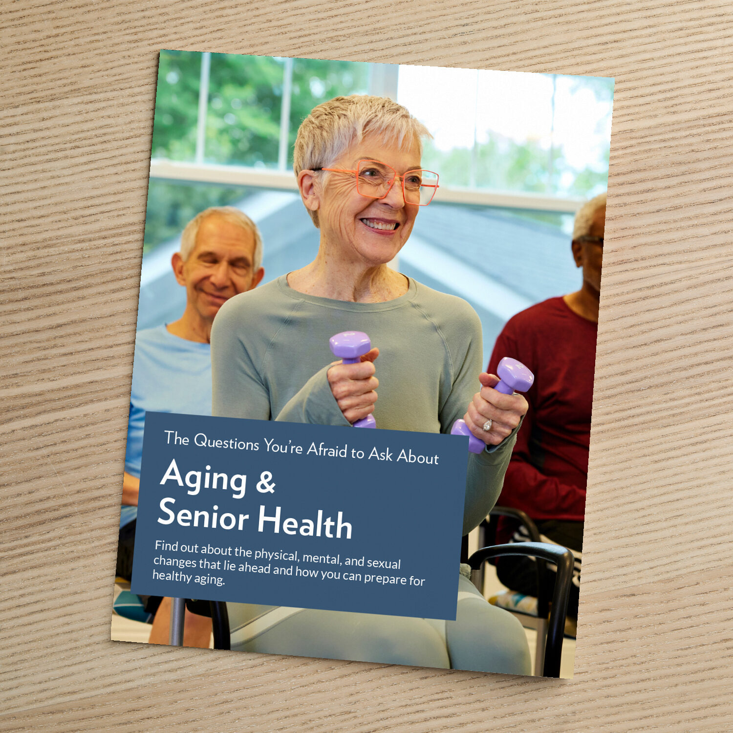 Cover of a guide titled "The Questions You're Afraid to Ask About Aging and Senior Health," featuring an older woman smiling and lifting small hand weights during a group exercise class.