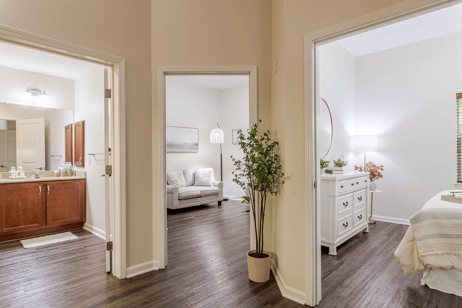 Bright hallway entrance leading into a well-appointed apartment with wood flooring, showcasing the inviting layout of assisted living in Alpharetta, GA and senior apartments in Alpharetta, GA.