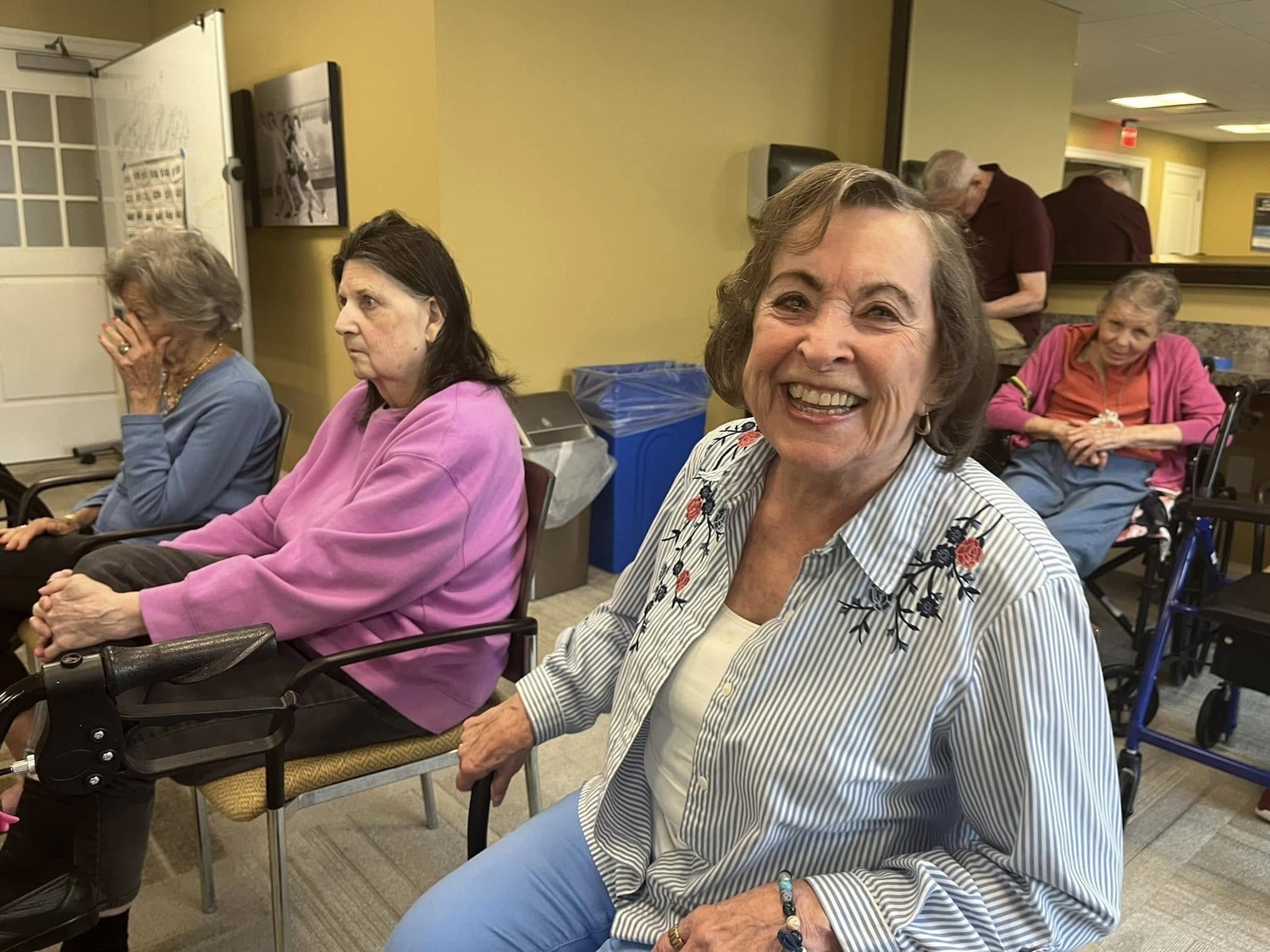 A resident smiles warmly during a group activity at The Solana Doylestown, a welcoming assisted living community in Warrington, PA.