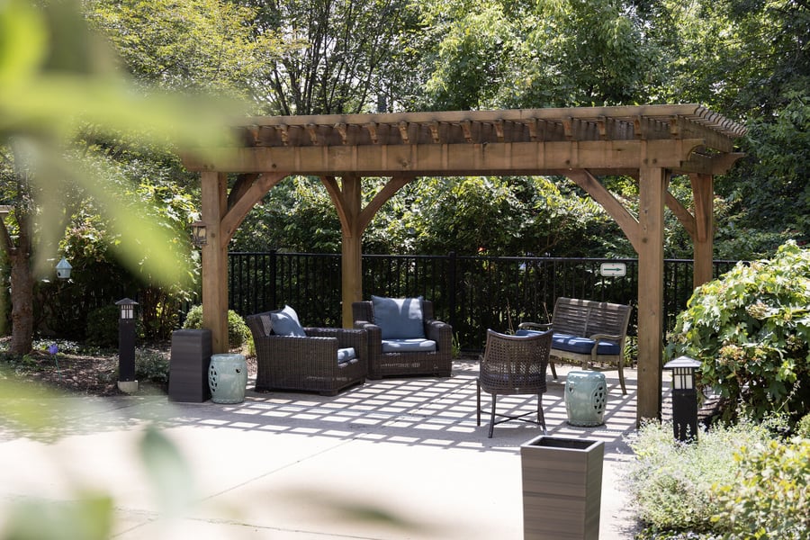 a relaxing, shaded gazebo sitting area in garden of a senior living community in Doylestown