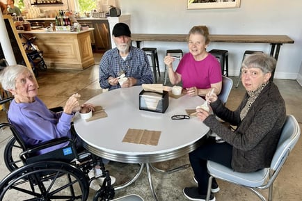 Residents from The Solana Doylestown enjoying ice cream together at a local café, seated around a table and engaging in a fun, relaxed social outing.