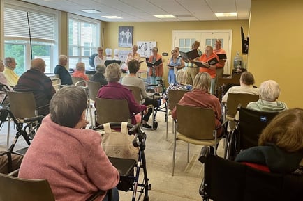 a group of seniors watching a live performance