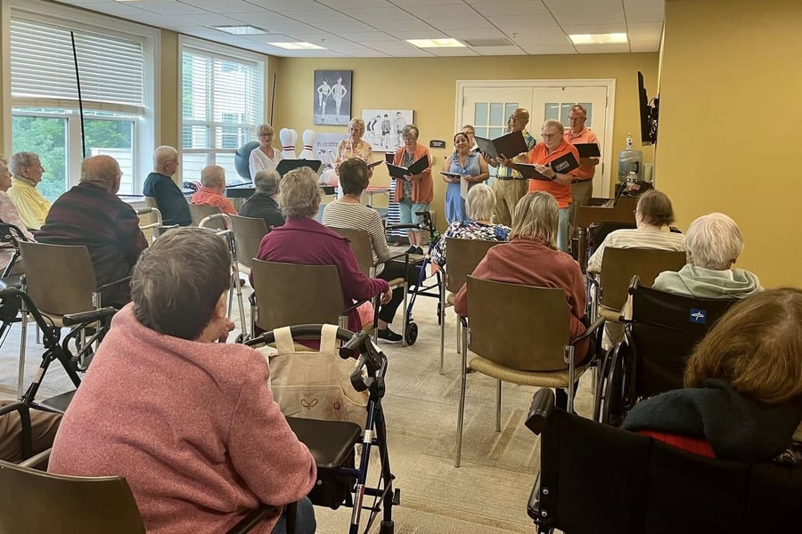 a group of seniors watching a live performance