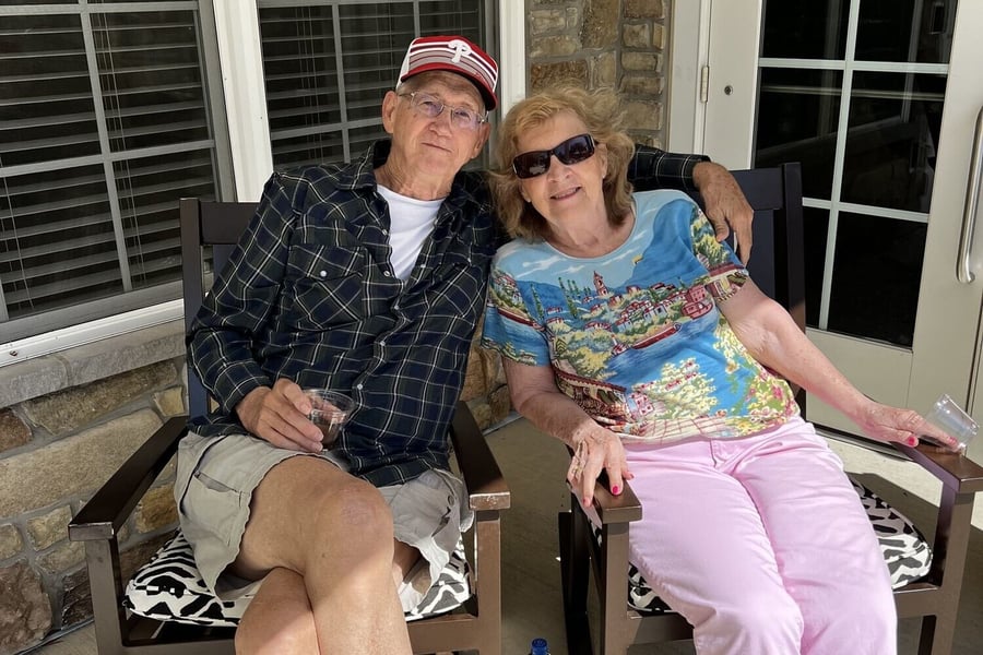a senior couple sitting on the patio