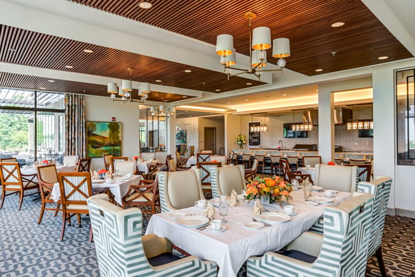 a luxurious dining room with carpeted floors and wood accents