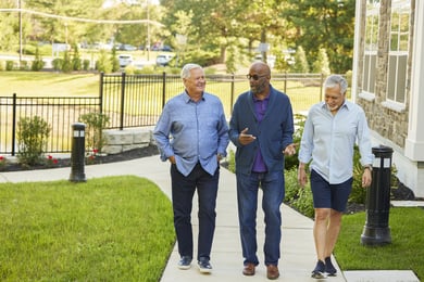 Senior men walking down a sidewalk outside