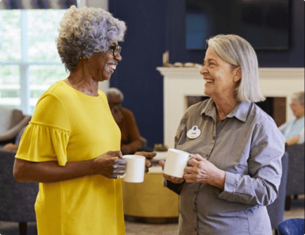 Two women sharing a cup of coffee.