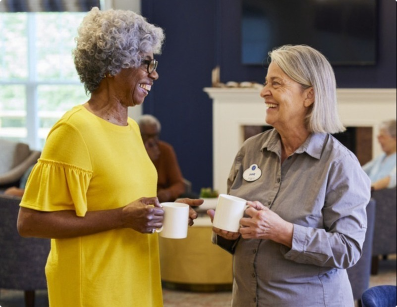 Two women sharing a cup of coffee.