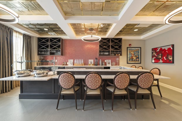 The bar and dining area at Arbor Terrace Glenview senior living features an elegant ceiling and comfortable seating, part of the senior living with gourmet dining North Shore experience.