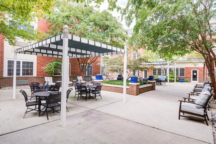 Arbor Terrace Senior Living Greenbelt Patio Area with a pavilion and table seating 