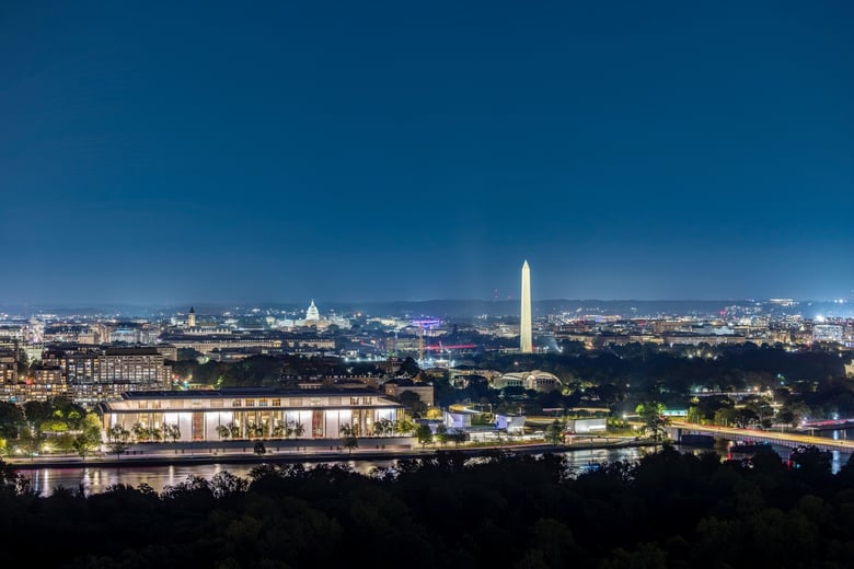 An aerial evening view of the Lanham, MD area with the Washington Monument visible on the horizon, highlighting the convenient location of this senior living community in Lanham, MD.