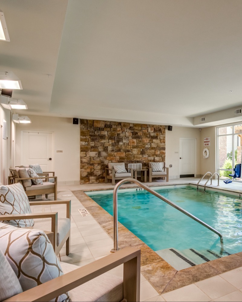 A serene indoor pool area offering residents a calm and inviting space to stay active, reflecting the wellness and fitness programs for seniors in Dacula available at this community.