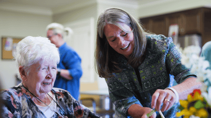 resident and staff doing crafts