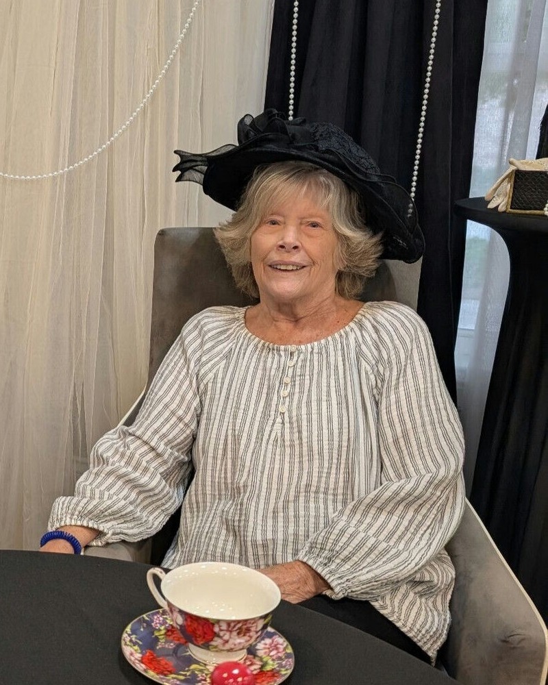 A senior resident smiles warmly while enjoying a cup of tea, embracing a peaceful morning routine at this assisted living community near Hamilton Mill.