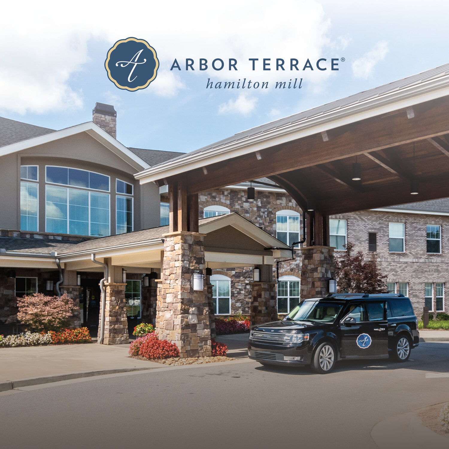 The welcoming exterior entrance of Arbor Terrace Hamilton Mill featuring stone architecture, a covered drive-through, manicured landscaping, and a community vehicle, a premier senior living community in Dacula, GA.