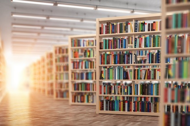 Warm sunlight pours across tall wooden shelves filled with colorful books in a bright, open library, a welcoming place for lifelong learning and one of the senior living resources on Chicago's North Shore near assisted living Highland Park IL.