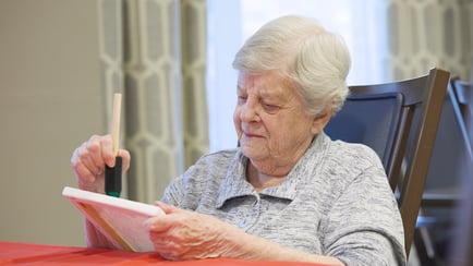 A resident enjoys a quiet painting session at Arbor Terrace Highland Park, part of the vibrant senior living lifestyle in Highland Park, IL. Creative moments like this bring warmth and connection to everyday life on Chicago's North Shore.