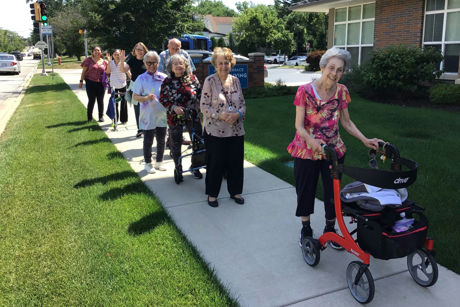 Senior residents walking down sidewalk in a line