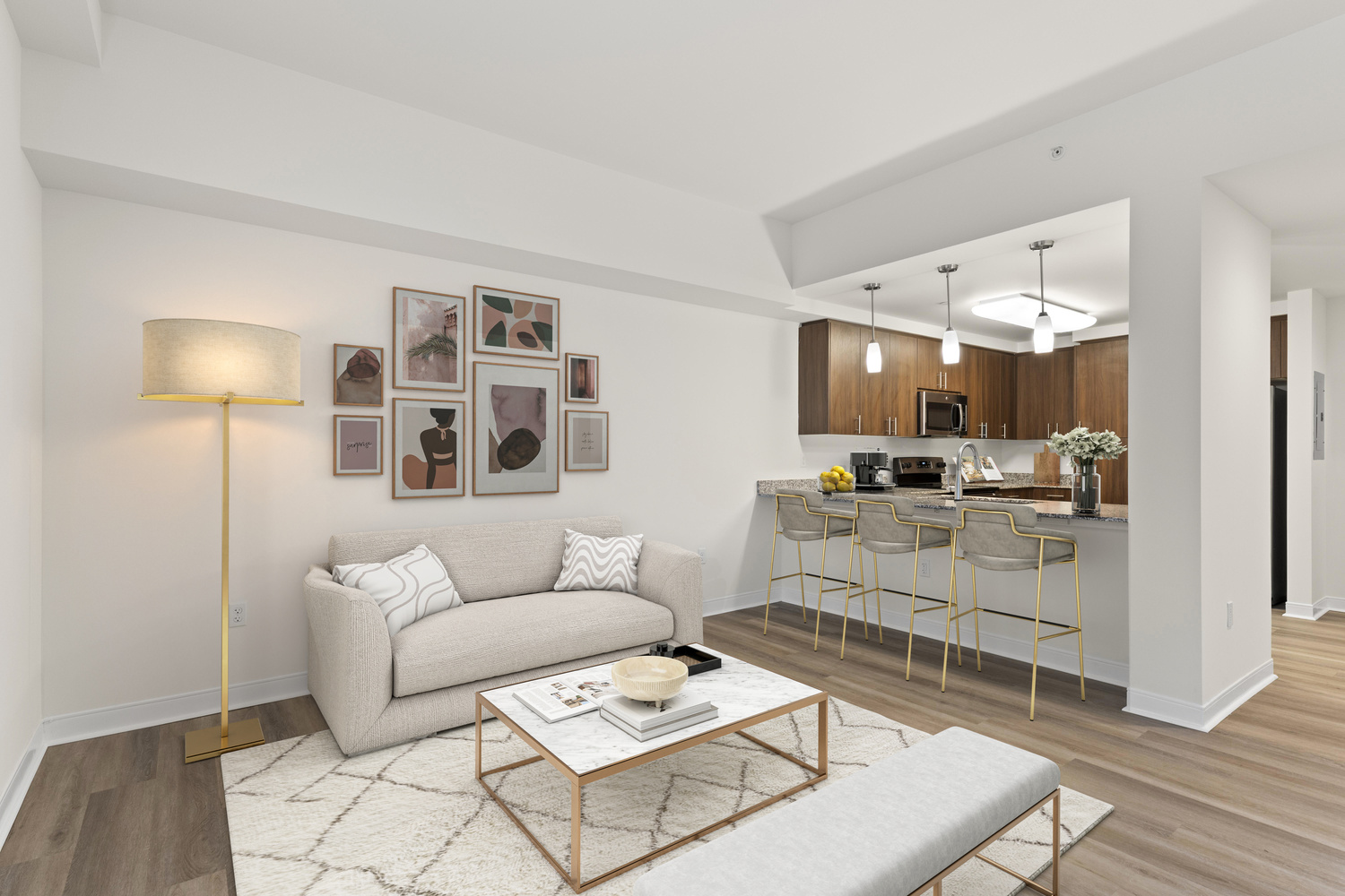 A living room at The Arbor at Lake Worth with a full kitchen and bar space.