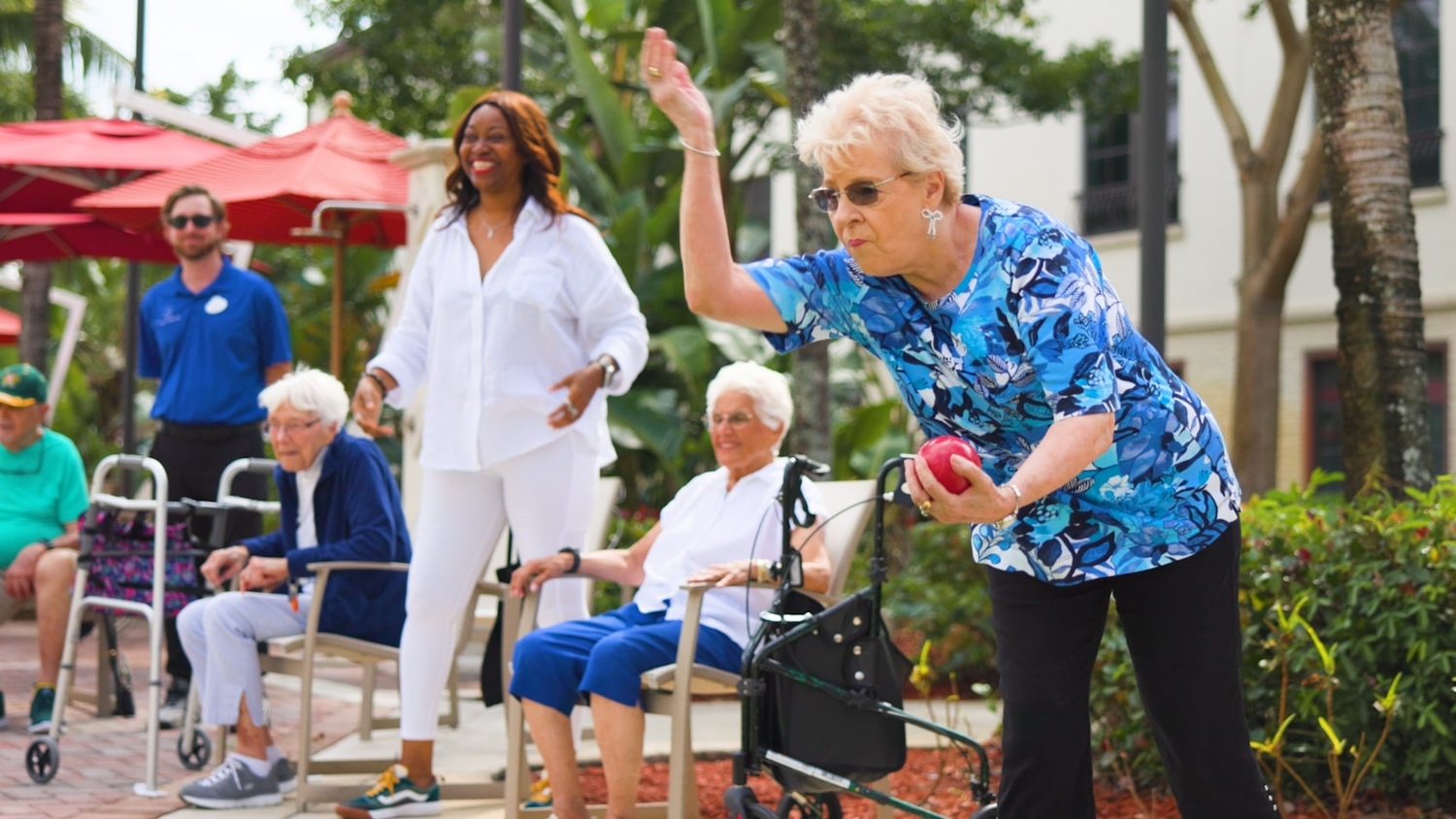 Senior residents enjoying a fun cornhole game at the garden