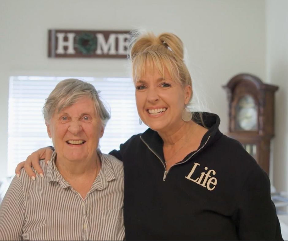 a senior resident and loved one smiling
