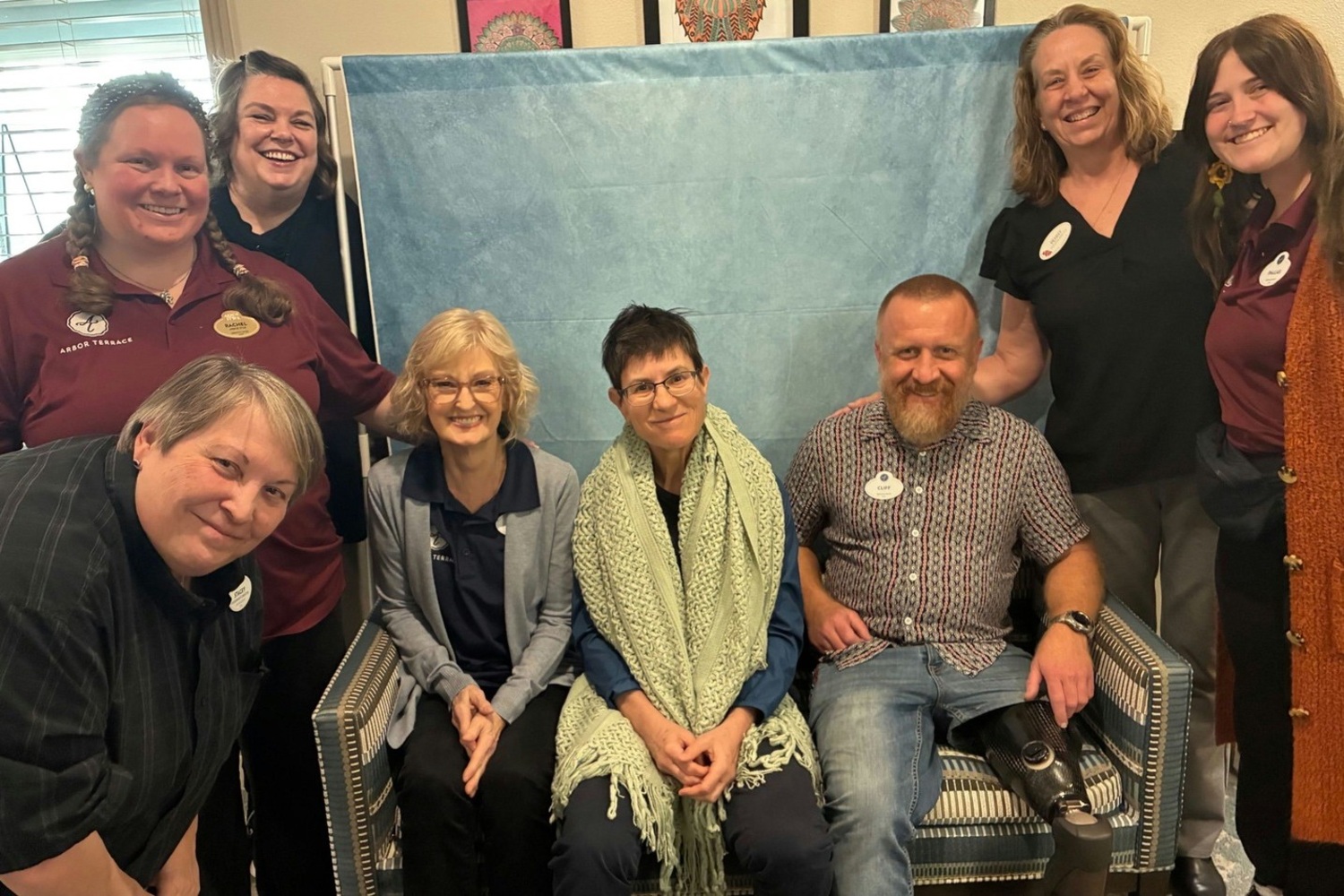 A warm group of staff members poses together with smiles at this assisted living community in Lakeway, TX, reflecting the dedicated and caring team that supports residents at Arbor Terrace Lakeway.
